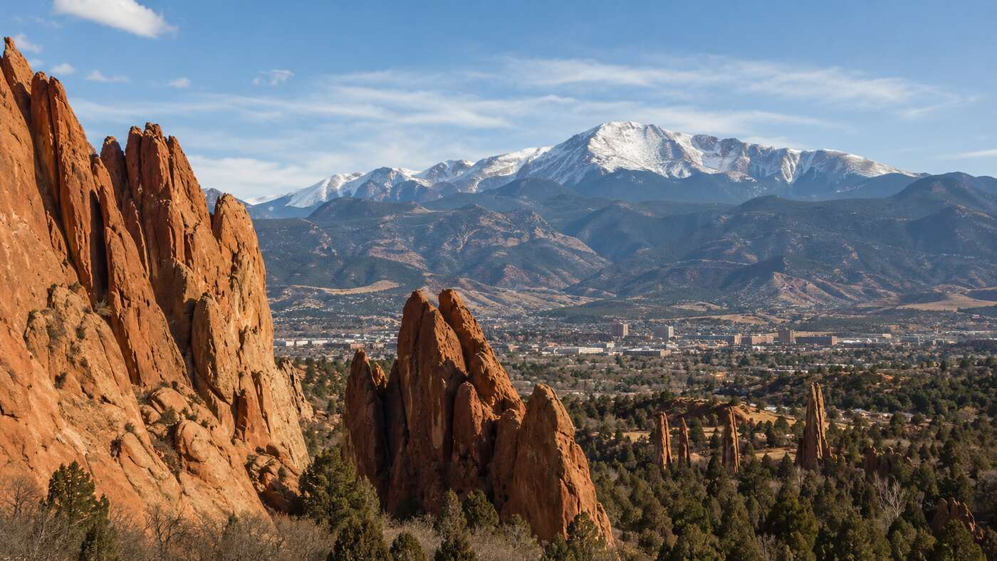 Colorado Springs business district and red rock formations beneath Pikes Peak Colorado Springs business district and red rock formations beneath Pikes Peak